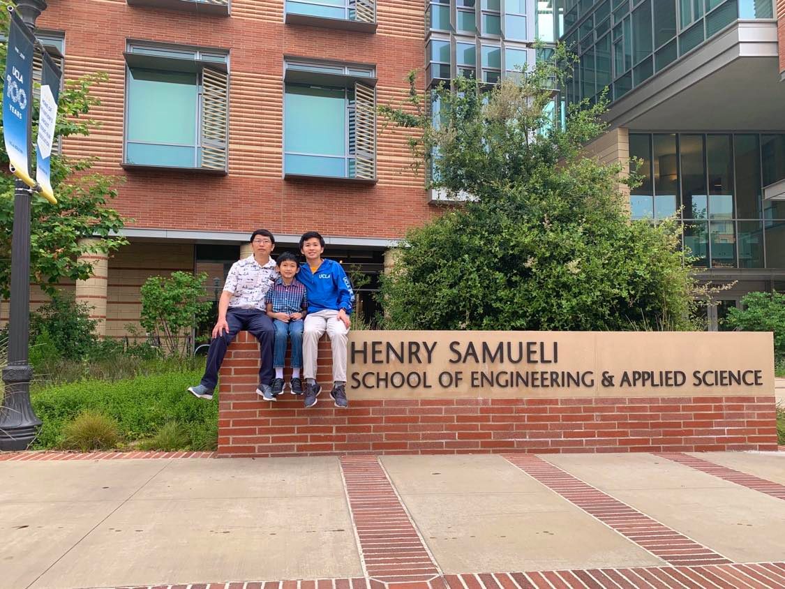 My dad, me, and my brother on the Samueli sign